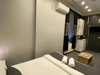a bedroom with a bed with two towels on it at Sahrakent Otel Pendik in Istanbul