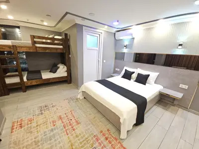 a bedroom with a bed and two bunk beds at Sahrakent Otel Pendik in Istanbul