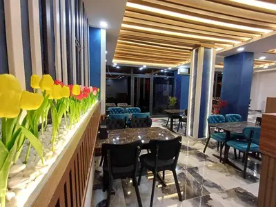 a restaurant with tables and chairs and flowers on the wall at White Palace Haliç in Istanbul