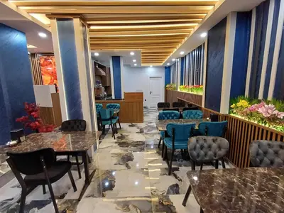 a lobby with tables and chairs and flowers at White Palace Haliç in Istanbul