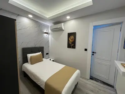 a small bedroom with a bed and a door at White Palace Haliç in Istanbul