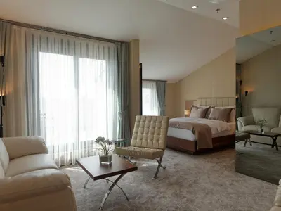 a bedroom with a bed and a living room at Inera Hotel Pendik in Istanbul