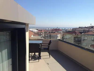 a balcony with a table and chairs on a roof at Inera Hotel Pendik in Istanbul