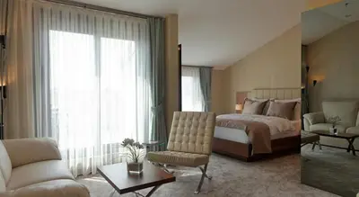 two pictures of a bedroom with a bed and a living room at Inera Hotel Pendik in Istanbul