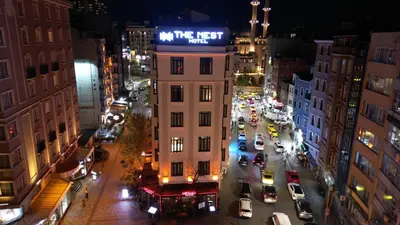 a building with a sign on it on a city street at THE NEST HOTEL in Istanbul