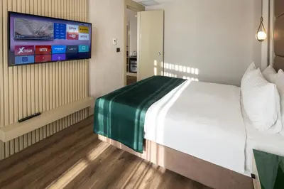 a hotel room with a bed and a flat screen tv at THE NEST HOTEL in Istanbul