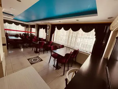 a dining room with red chairs and a table at YUNUS OTEL in Istanbul