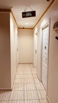 a hallway with a door and a sign on the ceiling at YUNUS OTEL in Istanbul