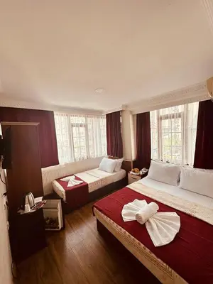 a hotel room with two beds and a window at YUNUS OTEL in Istanbul