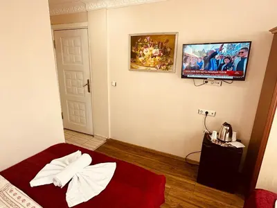 a room with a bed and a tv on the wall at YUNUS OTEL in Istanbul