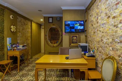 a room with a table with a laptop on it at Walnut Shell Hotel in Istanbul