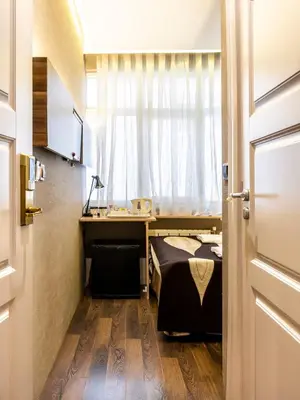 a bedroom with a bed and a desk and a window at Golden Gate Hotel Topkapı in Istanbul