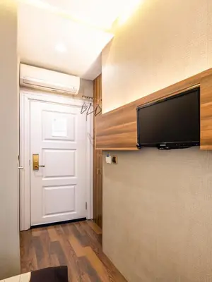 a room with a door and a television on a wall at Golden Gate Hotel Topkapı in Istanbul