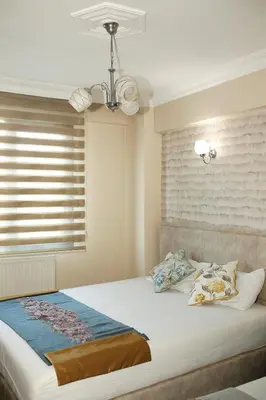 a bedroom with a large bed with a window at Birlik Apart Hotel in Istanbul
