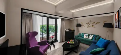 a living room with a blue couch and a purple chair at Sura Hagia Sophia Hotel in Istanbul