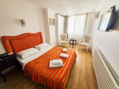 a bedroom with an orange bed with towels on it at My Way Tera Butik Otel in Adalar