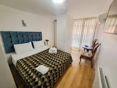 a bedroom with a large bed and a chair at My Way Tera Butik Otel in Adalar