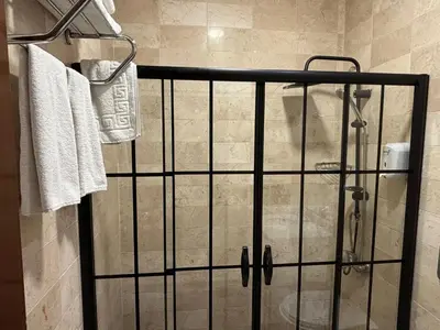a shower with a glass door in a bathroom at Nil Hotel İstanbul City Center in Istanbul