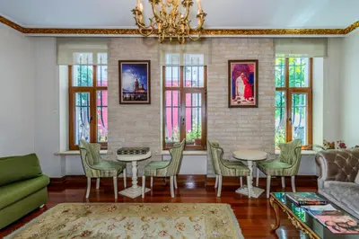 a living room with a table and chairs and a chandelier at Nil Hotel İstanbul City Center in Istanbul