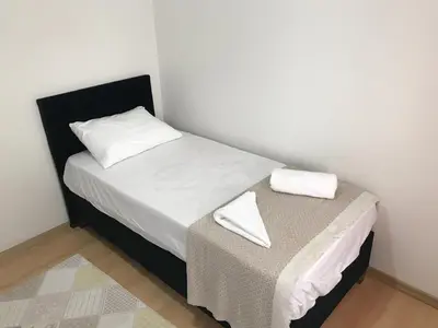 a small bedroom with a small bed with white sheets at Apartment sultanahmet in Istanbul