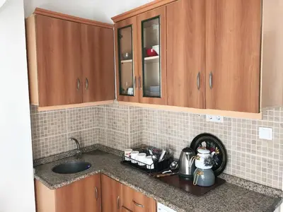 a kitchen with wooden cabinets and a counter top at Apartment sultanahmet in Istanbul