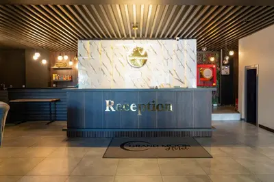 a restaurant with a blue counter in a lobby at GRAND MOON HOTEL in Esenyurt
