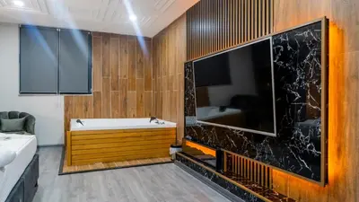 a bathroom with a tub and a large tv at GRAND MOON HOTEL in Esenyurt