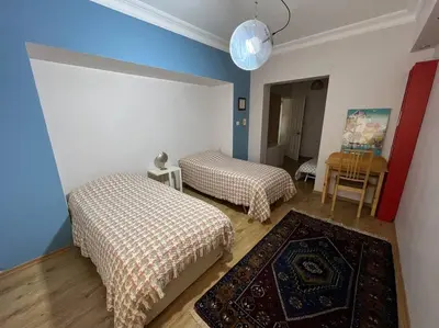 two beds in a room with blue and white walls at Bosphorus waterfront flat, Cengelköy in Istanbul