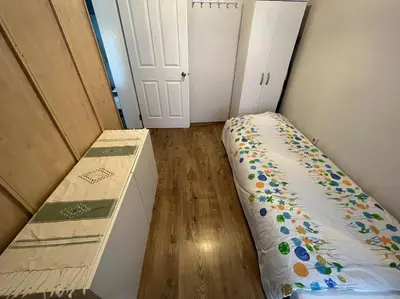 a small room with a bed and a wooden floor at Bosphorus waterfront flat, Cengelköy in Istanbul