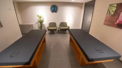 a hospital room with two beds and two chairs at Park Inn by Radisson Yalova City Center in Yalova