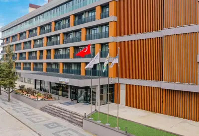 an office building with flags in front of it at Park Inn by Radisson Yalova City Center in Yalova
