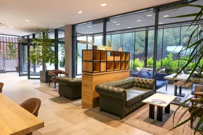 a lobby with a couch and tables and windows at Park Inn by Radisson Yalova City Center in Yalova