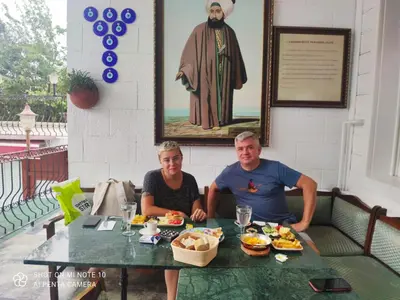 a man and woman sitting at a table with food at Solomon's Mansion Hotel Istanbul in Istanbul