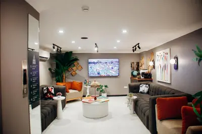a living room with couches and a large screen at Istiklal Street Taksim House Yamalya Hotel in Istanbul