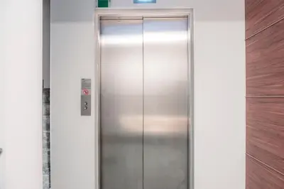 an elevator in a building with a sign on it at Homie Suites - Luxury Apartments in Maçka in Istanbul