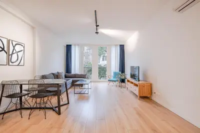 a living room with a table and chairs and a couch at Homie Suites - Luxury Apartments in Maçka in Istanbul