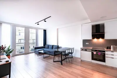 a kitchen and living room with a table and chairs at Homie Suites - Luxury Apartments in Maçka in Istanbul