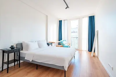 a bedroom with a large white bed and a desk at Homie Suites - Luxury Apartments in Maçka in Istanbul