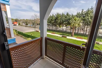 a balcony with a view of a park with benches at Olinda Hotel & Spa in Sile