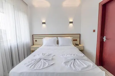 a white bed with two white pillows on it at Olinda Hotel & Spa in Sile