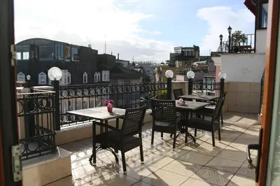 a patio with tables and chairs on a balcony at Grand Peninsula Hotel in Istanbul