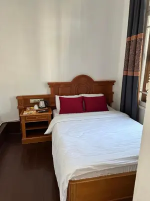 a bedroom with a large bed with red pillows at Laden Palas Prince's Island Historical Mansion in Adalar