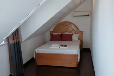 a bedroom with a bed with red pillows at Laden Palas Prince's Island Historical Mansion in Adalar