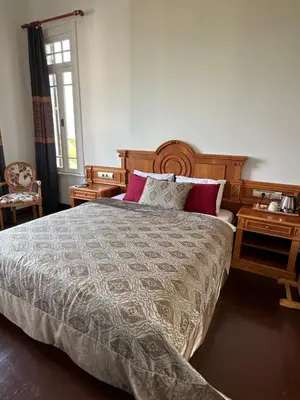 a bedroom with a large bed and two night stands at Laden Palas Prince's Island Historical Mansion in Adalar