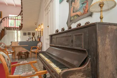 an old piano in a room with a dining room at Laden Palas Prince's Island Historical Mansion in Adalar