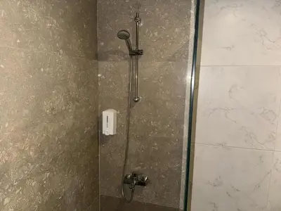 a shower in a bathroom with a glass door at Aderans Hotel in Istanbul