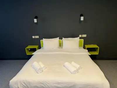 a large white bed with two white towels on it at Aderans Hotel in Istanbul