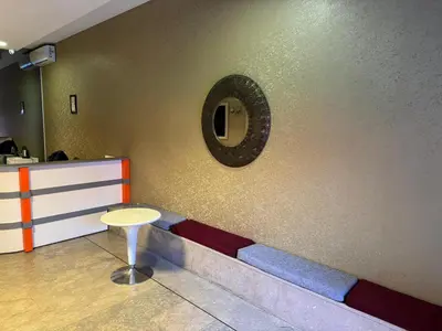 a waiting room with a table and a mirror on the wall at Aderans Hotel in Istanbul