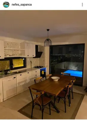 a kitchen with a wooden table and chairs in a kitchen at Nefes Vılla Sapanca in Sakarya