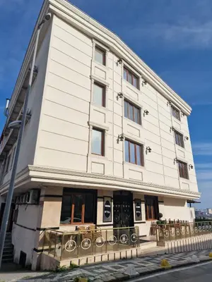 a large white building with windows on a street at Sahra Airport Hotel in Istanbul